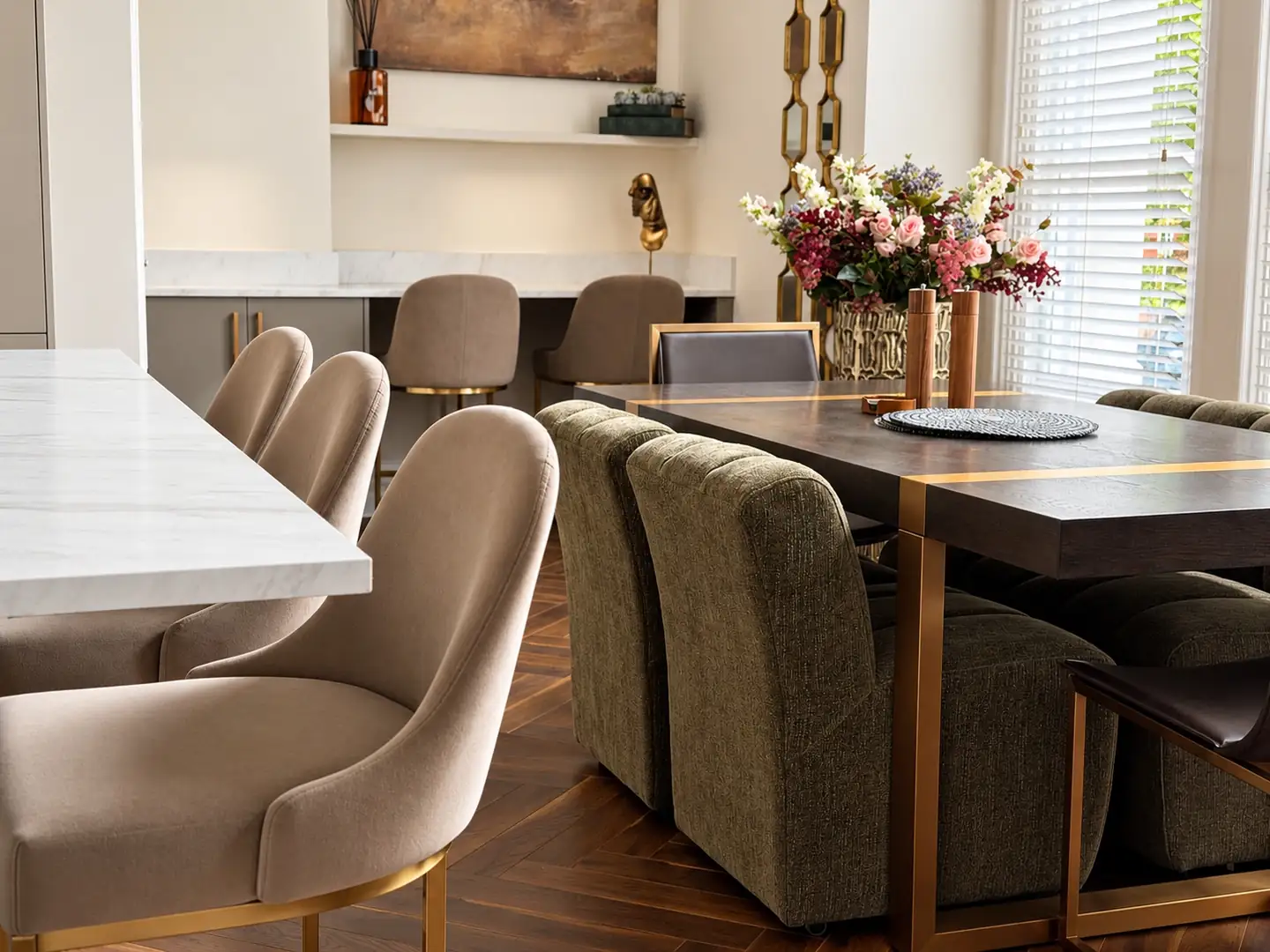 Velvet bar stools and dining chairs with flowers on the table